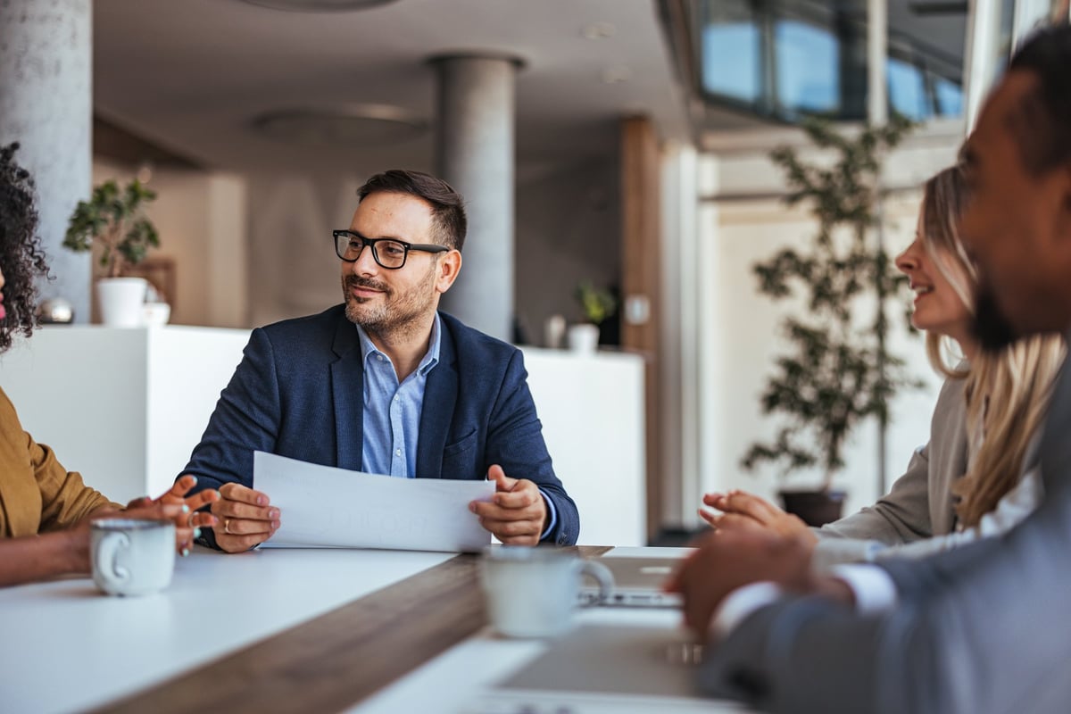 A diverse team engages in a productive business meeting in a modern office, representing local Pasco business growth